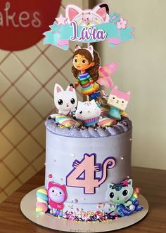 the birthday cake is decorated with cartoon characters