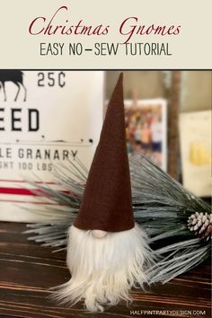 a gnome's hat sitting on top of a table next to a christmas sign