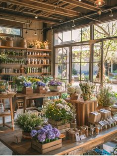 an indoor flower shop with lots of plants and flowers on display in the window sill