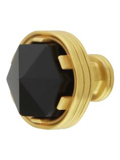 an image of a black stone knob on a gold plated cabinet door with screws