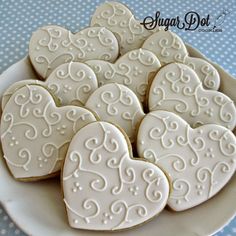 some heart shaped cookies on a white plate