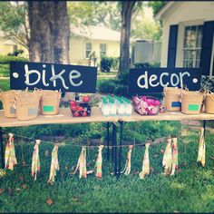 a table topped with baskets filled with fruit next to a sign that says bike decor