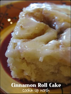 a close up of a piece of cake on a plate with the words cinnamon roll cake