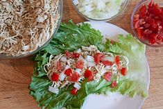 lettuce, onions and tomatoes are on a plate next to other food items