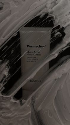 a black and white photo of some paint on the wall with text that reads dermacler