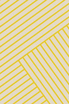 a yellow and white striped wallpaper with vertical lines in the center, as well as diagonal stripes