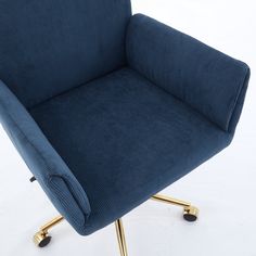 a blue chair sitting on top of a metal frame with gold legs and wheels in front of a white background