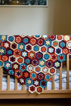 a crocheted blanket on top of a wooden bed