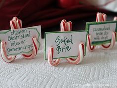 three candy canes with name tags on them sitting on a white tablecloth, and the caption reads keep your place