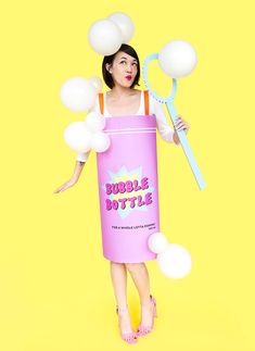 a woman in a bubble bath costume is holding a toothbrush and some soap bubbles