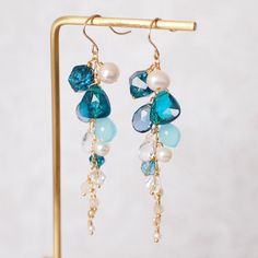 >> Like my design? Follow me on Instagram to stay updated on new design and watch product video! << http://instagram.com/faithanddeedsjewelry These gorgeous, mouthwatering earrings are made with a number of beautiful gem stones, carefully and meticulously wire-wrapped and put together to create this long dangling design. I have used london blue quartz, pearls, teal quartz, blue chalcedony, clear quartz, aquamarine and moonstone in this design. One of a kind style that speaks style an Stone Dangle Earrings, Blue Quartz, Blue Chalcedony, Multi Stone, Jewelry Inspo, Stone Earrings, Clear Quartz, Designer Earrings, Beautiful Earrings