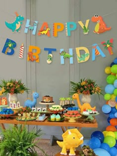 a dinosaur birthday party with balloons and decorations