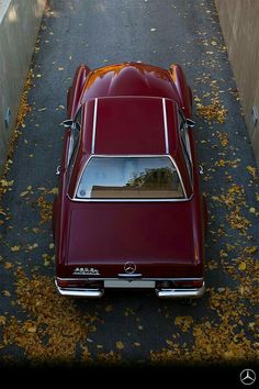 an old car is parked on the side of the road