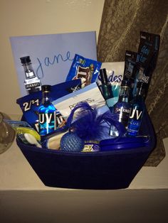 a blue basket filled with personal care items on top of a counter next to a sign