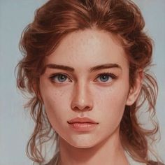 a woman with freckled hair and blue eyes