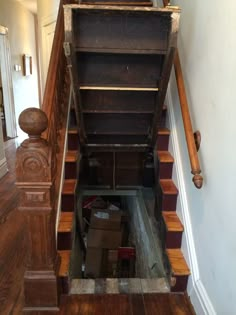 an old wooden staircase with boxes on the bottom