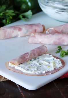 bacon, cheese and herbs on a cutting board