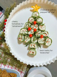 a christmas tree made out of sushi rolls and crackers on a platter