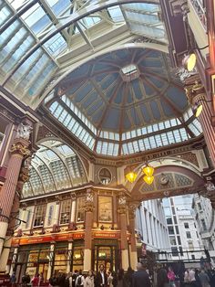 the inside of a building with many people walking around