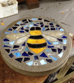 there is a mosaic on the ground with a bee