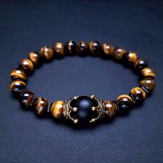 Tiger Eye - lets you see everything. Use it for insight and you can be a very lucky person. When used in jewelry the tiger eye may bring good luck and protection from the evil eye to the wearer. It is also known to bring clear thinking and insight. Style: ClassicShape\pattern: CROWNOcassion 4: Friendship braceletOcassion 3: Lover braceletsOcassion 2: bracelets giftOcassion 1: Couple braceletsMaterial : Natural Stones braceletGender: UnisexChain Type: Beaded Bracelet Elegant Brown Stretch Bracelet With 8mm Beads, Bead Bracelet Ideas, Mens Bracelet Fashion, Lovers Bracelet, Men Bracelet, Bead Bangles, Tigers Eye Gemstone, Tiger Eye Beads, Natural Stone Bracelets