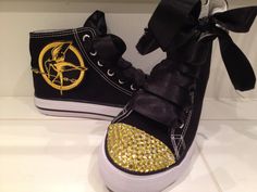 a pair of black and gold converse sneakers