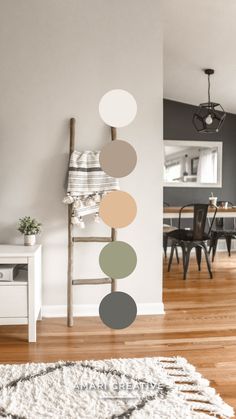 a living room with a ladder, table and chair in the corner next to a white rug