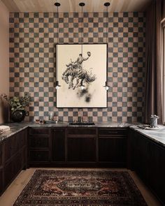 a kitchen with checkered wallpaper and wooden cabinetry, along with a rug on the floor