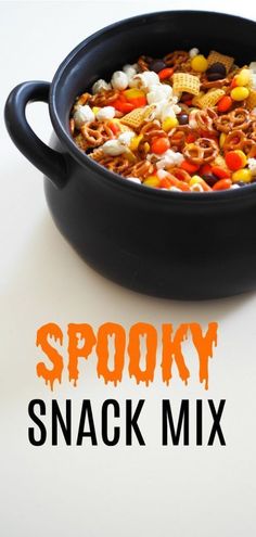 a black bowl filled with spooky snack mix on top of a white table