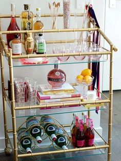 a gold bar cart filled with bottles and glasses