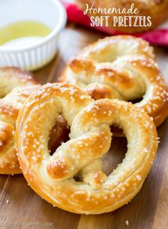 some pretzels are sitting on a table with dipping sauce