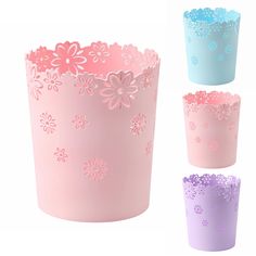 four different colored paper cups with flowers on the inside and outside, all decorated in pastel colors