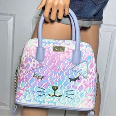 Luv Betsey Johnson Lini Dome Pastel Kitty Cat Print Bag Nwt Gorgeous Bag For Spring Or Easter Beautiful Pastel Colors: Pink, Purple, Green, Blue A Crossbody For Every Occassion, The Luv Betsey Lini Dome Handbag Is Just The Right Size And Style To Be Taken On Any Exciting City Adventure You May Encounter. Kitty Cat Face Details On Bag. Crossbody Strap. Top Zipper Closure. Handles For Easy Carry. Roomy Interior. Gold Tone Hardware. Constructed Of Pu (Polyurethane). 100% Polyester Lining. Approxima Cute Multicolor Satchel With Adjustable Strap, Cute Multicolor Hello Kitty Print Bag, Cute Purple Satchel Bag, Cute Multicolor Bag With Detachable Strap, Trendy Pink Cat Design Bags, Playful Purple Bag For Everyday Use, Playful Multicolor Bags With Cat Design, Pastel Kitty, Betsy Johnson Bags