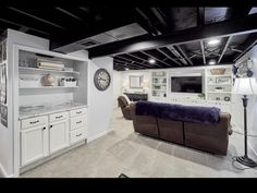 a living room filled with furniture next to a kitchen