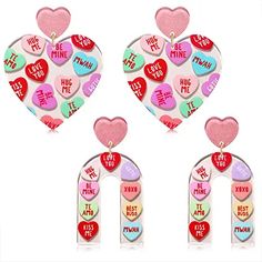 three heart shaped earrings with words and hearts on the front, two are pink, one is