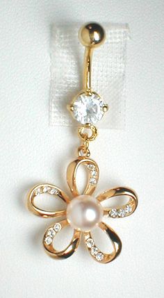 an image of a gold flower belly button ring with pearl and crystal stones on it