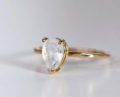 14k solid gold faceted cut pear shaped moonstone engagement ring. This beautiful moonstone ring was made of 14k solid yellow gold band and 8x6mm pear shaped faceted cut moonstone in 14k yellow gold prong setting . This ring is handcrafted in my California Studio. ***14k yellow gold band is 1.3mm thickness . ***Moonstone is 8x6mm pear shaped faceted cut. Rainbow Moonstone Engagement Ring, Gold Moonstone Ring, 50th Birthday Gifts For Woman, Jewelry Design Studio, June Birthstone Ring, Moonstone Engagement, Moonstone Engagement Ring, Rainbow Moonstone Ring, Emerald Engagement