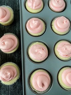 cupcakes with pink frosting in a muffin tin