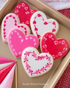 decorated heart cookies in a box on a table