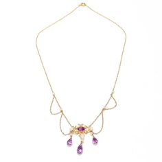 A fine Edwardian style festoon necklace.  In 14 karat yellow gold.  Centered on an ornate gold yolk with a bezel-set oval-cut amethyst.   Supporting 3 drops with freshwater river pearls and briolette-cut amethysts and flanked by several festooned swags punctuated by pearl mounts to the chain.  Simply a wonderful, delicate festoon necklace!  Date:  20th Century  Overall Condition: It is in overall good, as-pictured, used estate condition with some fine & light surface scratches and other signs of expected light wear consistent with age.  Fineness: Marked 14k for gold fineness.   Marks: Marked 14 to the clasp.  Gemstone Measurements: Amethyst cabochon: ca. 6.5 x 4.23 x  3.27 mm Largest Amethyst Drop: Length: ca. 9.5 mm Diam: ca. 5.2 mm  Measurements: Chain Length: ca. 16 in. Pendant: Height: Vintage Amethyst Yellow Gold Necklace, Vintage Amethyst Necklace In Yellow Gold, Formal Yellow Gold Amethyst Necklace, Elegant Purple Oval Pendant Necklace, Art Nouveau Yellow Gold Gemstone Necklaces, Elegant Purple Filigree Necklace, Formal Oval Art Nouveau Necklace, Victorian Hallmarked Purple Necklace, Victorian Style Hallmarked Purple Necklaces