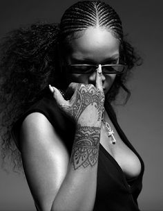 a woman with tattoos on her arm covering her mouth