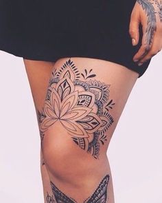 a woman's thigh with tattoos and butterflies on it