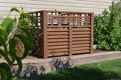 a wooden planter sitting in the middle of a yard