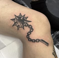 a person with a tattoo on their arm has a chain and star tattooed on it