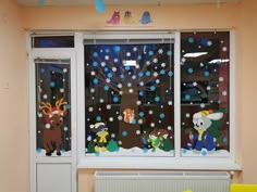 the window is decorated with animals and snowflakes