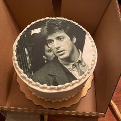 a cake in a box with an image of the famous actor on it's side