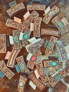 several pieces of wood with designs on them sitting on top of a fur covered surface