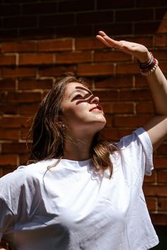 A girl with her hand up towards the sun, the shadow across her face. Looking Up Head Reference, Blocking The Sun With Hand Pose, Head Resting On Arms Pose, Shielding Eyes From Sun Pose, Hand On Forehead Reference