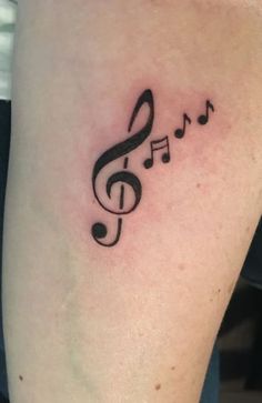 a tattoo with musical notes on it