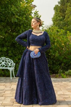 Adorned with intricate self-sequins, this deep blue masterpiece is sure to dazzle in the Adhara Lehenga. The look is completed with a full-sleeve blouse and a net dupatta that has been embellished with sparkling details. Pure luxury awaits in the Adhara Lehenga, an incredible work of art in a deep blue hue with intricate self-sequins that will leave you mesmerized. Team it up with an intricately designed full-sleeve blouse paired with a net dupatta embellished with sparkly details for the fashio Plain Lehenga With Heavy Dupatta, Full Sleeves Blouse Design For Lehenga, Full Hands Blouse Designs For Lehenga, Midnight Blue Lehenga, Lehenga Designs Full Sleeves, Elegant Blue Lehenga With Sequins, Anarkali Style Evening Blouse Piece With Zari Work, Anarkali Blouse Piece With Zari Work For Evening, Festive Evening Dupatta With Intricate Embroidery